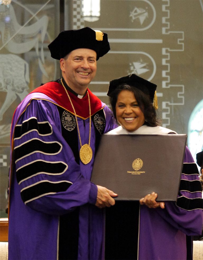 The Rev. James J. Maher, C.M., Niagara University president, presents Denise Góñez-Santos with an honorary Doctorate of Humane Letters