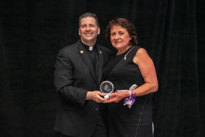 Philanthropist Ginesia Cortellucci accepts the St. Vincent de Paul Award from the Rev. James J. Maher, C.M., Niagara University president