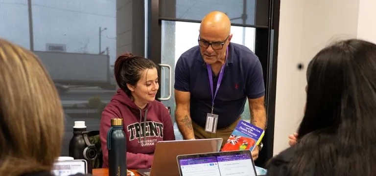 Teacher helping a student on the computer