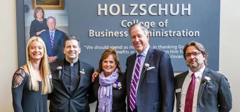 Father Maher and Dr. Mark Frascatore standing with donors Mr. and Mrs. Holzschuh at the ribbon cutting ceremony.