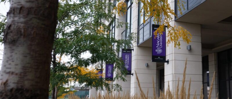 Outside of the Vaughan Campu Building with the Niagara University Purple Banners