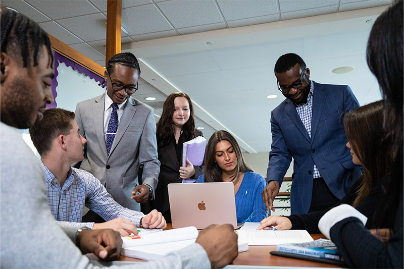 Business Students meeting and discussing content from books.