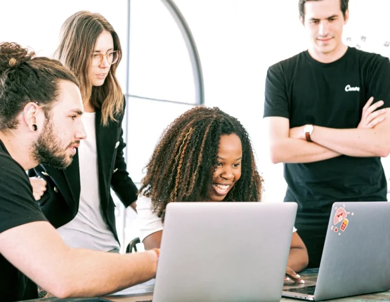 Grad students gathered around a laptop