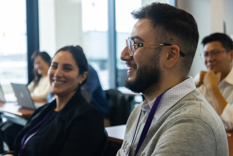 Side face of student smiling watching a lecture