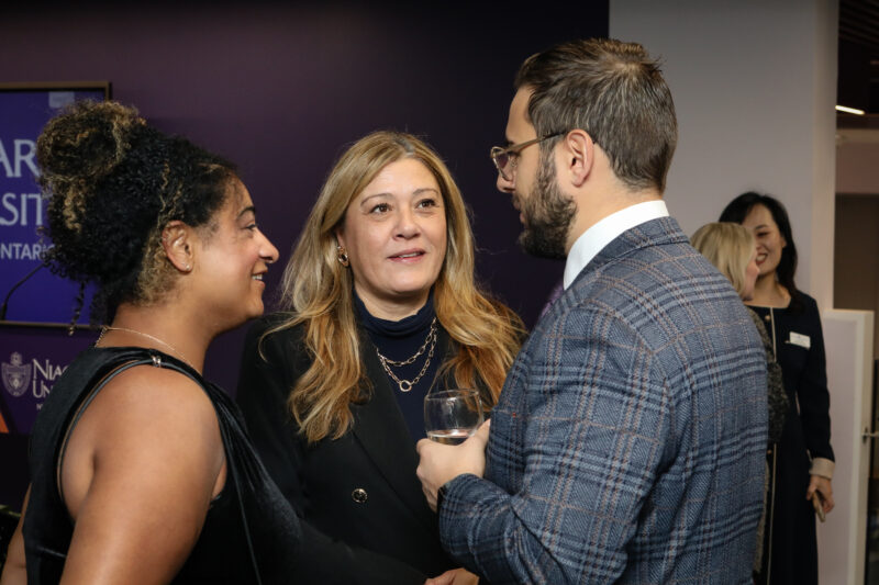 Three People talking in a circle with one holding a wine glass